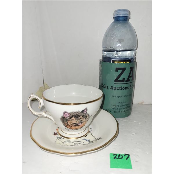Yukon tea cup with gold trim - cup has wolf, saucer has map
