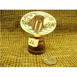 Colored scrimshawed ivory platchet of walrus and mountains in background signed J. on wood base (33)
