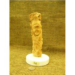 Incredible bone American Indian carving with eagle, owl, ram, buffalo, and other faces on marble bas