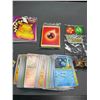 Image 3 : Lot of 1 Pokemon Storage Tin with Assorted Authentic Pokemon Cards, Mini Binder, Playing Dice, etc.