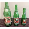 Image 1 : Lot of three vintage 7-Up bottles.  28 fl. oz., 12 fl. oz., 7 fl. oz..