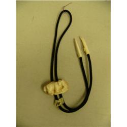 Outstanding ivory bolo tie by Eugene Tiliana done in 1973 - elephant in fossilized ivory with kayak 