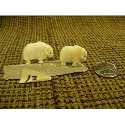 Pair of white ivory musk ox mounted on whale bone by Robert Kokuluk 3" long (2)