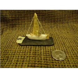2" ivory Eskimo sail boat with fossilized ivory seal and rudder with seal gut sail mounted on baleen