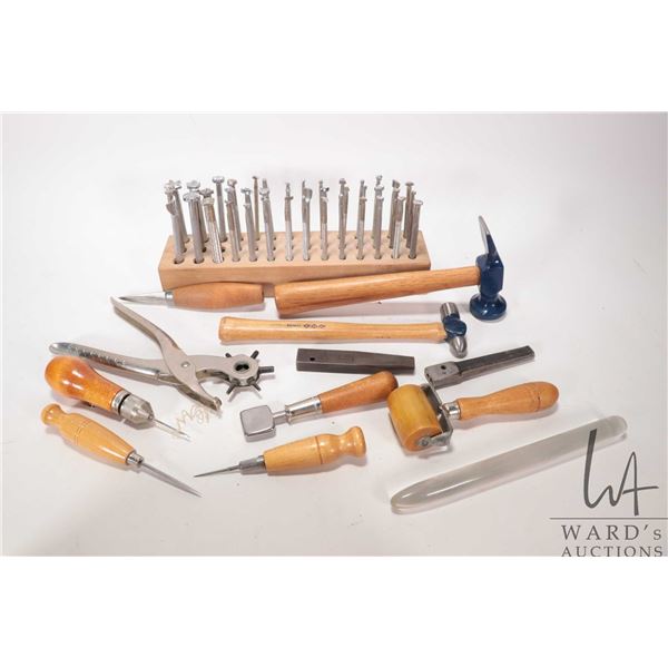 Selection of leather working tools including stamps, hammers, hole punch etc.