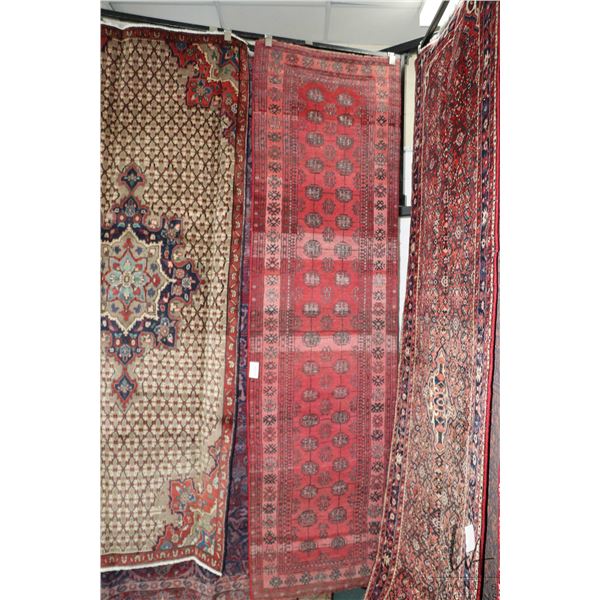 100% handmade Iranian wool carpet "Turkmann" with red background and overall geometric design with b