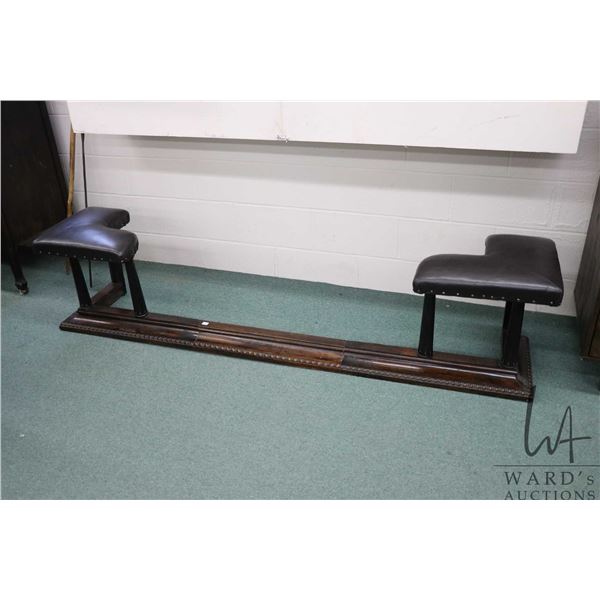 Antique hardwood club fireplace fender with re-upholstered seats sitting on top of reeded supports, 