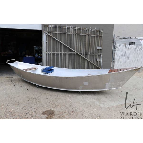 Custom made, all aluminum flat bottom drift boat with flared sides, pointed stern and dark stained w