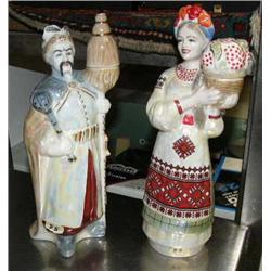 Lot of 2 ceramic figurines, male and female, can be used as tapered candle holder, and 2 wood Russia