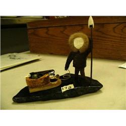 6.5" bone Eskimo man with ivory face and fur trim, ivory tipped spear and soapstone and bone sled on