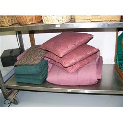 Lot of green and pink towels, pink bedspread, and pink pillows (172)