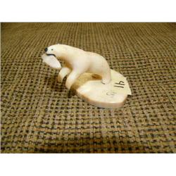 Ivory polar bear with fish in mouth on ivory base 2" high, 11.5" wide by Henry Noongwook (178)