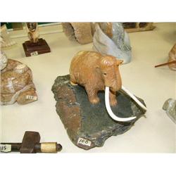 Soapstone mastodon with bone tusks on base 10" long, 8" high (33)