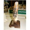 Image 1 : Fossilized walrus ivory with intricately scrimshawed portrait of man, signed Fisk on wood base, 9" t