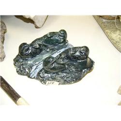 4 soapstone seals on base 7" long, 3" high (33)