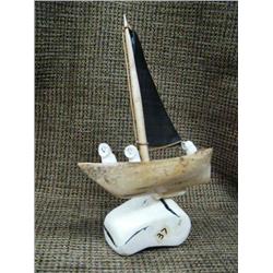Bone and baleen, ivory ship with three ivory natives 8" tall (33)