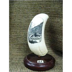Intricately carved whale's tooth of whale breaching with totems nearby signed by Peter Kwray 6" tall