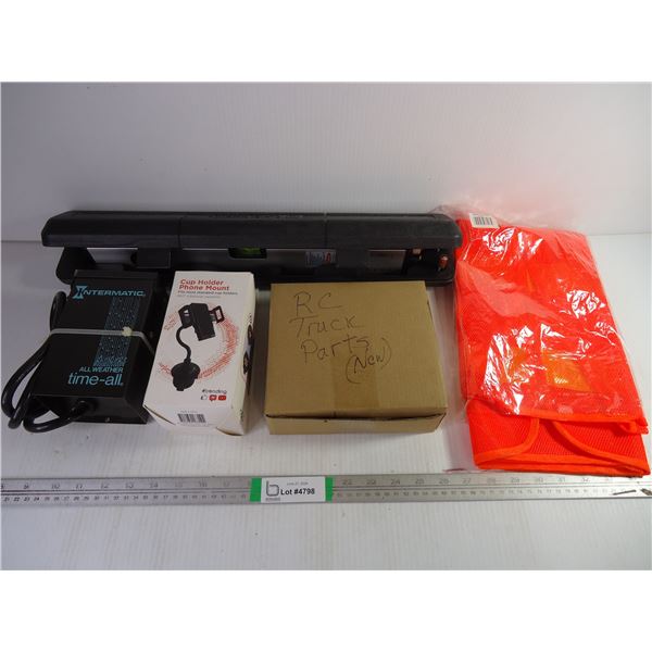 Laser Level, Outdoor Timer, Phone Mount, Safety Vest and box of Remote Control Truck Parts
