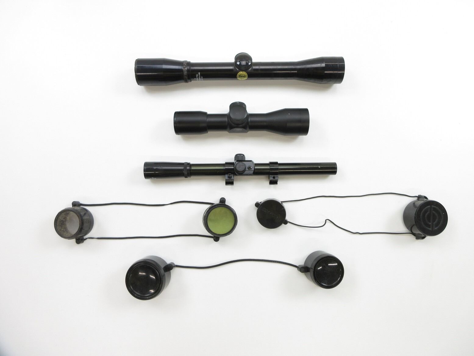 ASSORTED RIFLE SCOPES AND BIKINI-STYLE LENS CAPS LOT