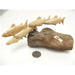 6.5" long bone carving of 5 swimming salmon on fossilized bone base (2)