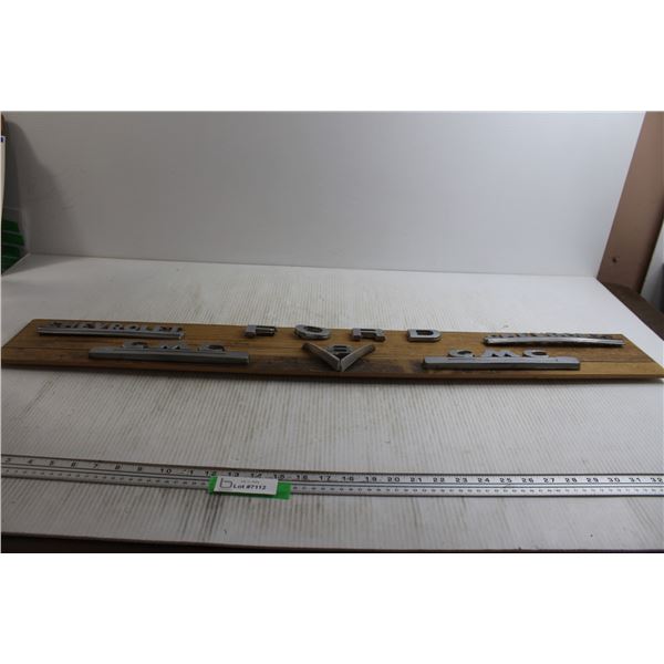 Assorted 1950's Truck Chrome Emblems on board-39"x6"