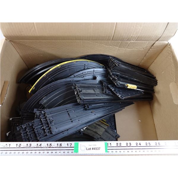 Box containing Race Car Tracks and Train Tracks