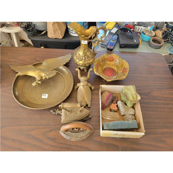 Variety of brass objects, sad irons, and various rocks.
