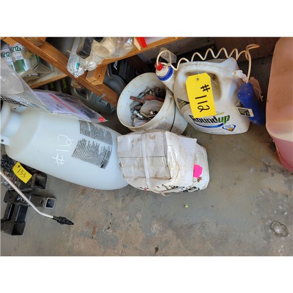 Jug of round up, sprayer, cleaning fluids, fishing rods, flags.