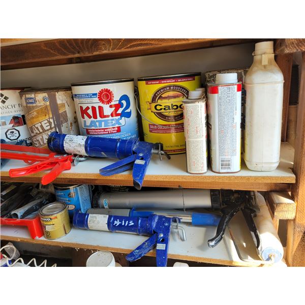 Various paints, caulking guns, brushes and rollers.