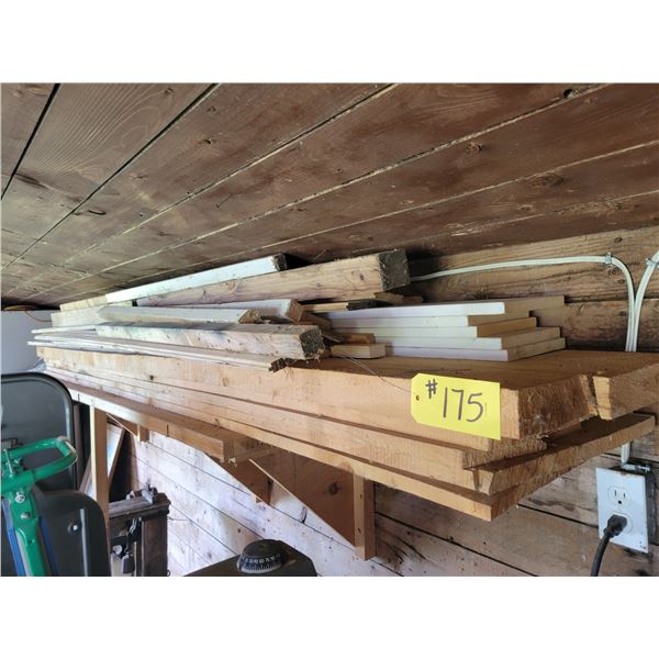 Various wood . On top of the shelf .