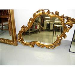 Beautiful carved gold colored framed mirror, cast (195)