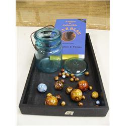 Collection of pottery marbles, book on Antique marbles and green glass jar reading Banner on front (