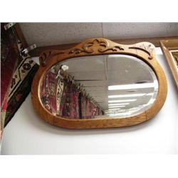 Wood framed oval mirror with ornate carvings (2)