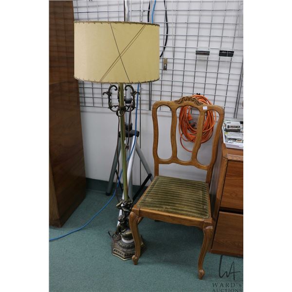 Cherub motif cast floor lamp and a vintage side chair with scroll feet