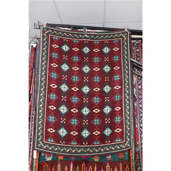 Wool rug with burgundy background and geometric pattern and highlights of greens, taupe, cream, 40" 