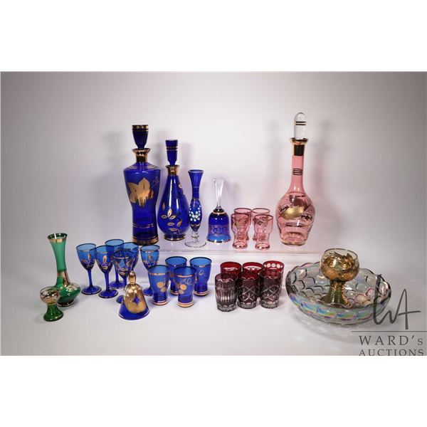 Selection of vintage and collectible glass including two gold overlay decanter and glass sets, Moser