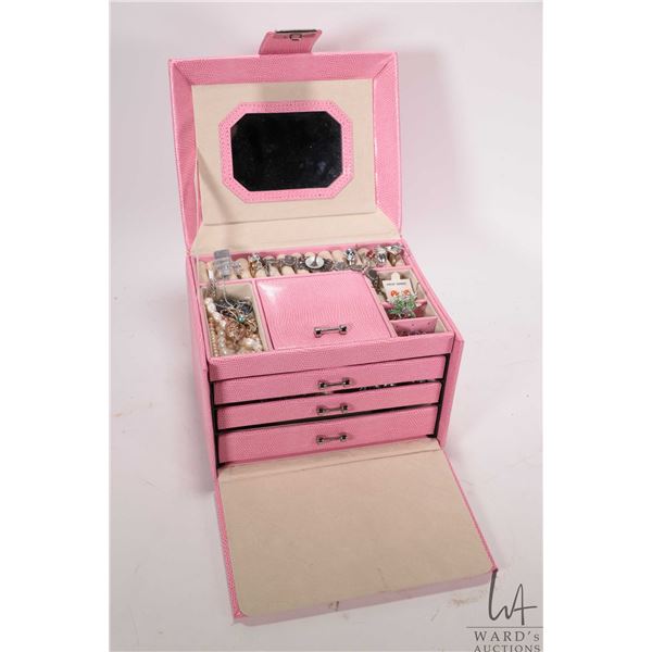 Pink jewellry travel box with flip up mirrored lid and three drawers, sections for rings and earring