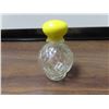 Image 1 : Small clear glass bottle with yellow top.