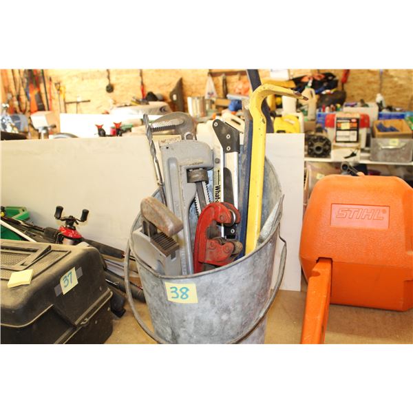 Pail of pipe wrenches, cutter and pry bars