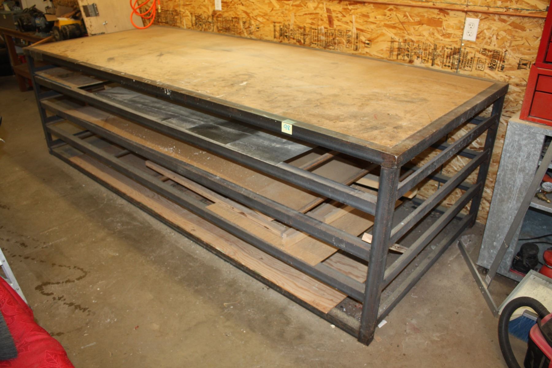 Steel storage work table with wood top. 120 ½” L x 48 ¼” W x 34”H, with v
