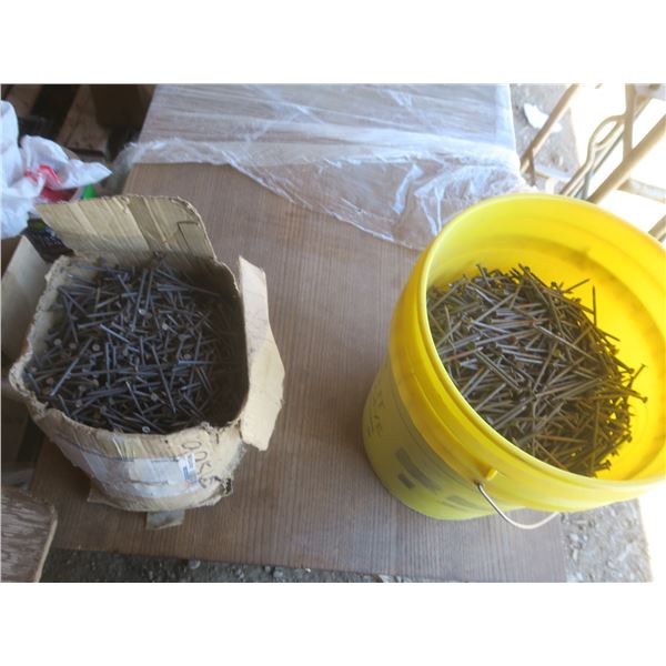 box and 5 gallon pale of nails