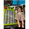 Image 1 : Doll, learning toy, and electrical outlets