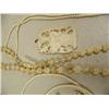 Image 3 : Lot of 5: beautiful carved ivory orchid, ivory pendant with gold rim, ivory peacock, ivory pendant a