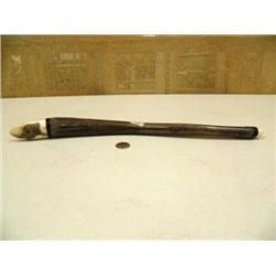Fossilized oosik 18" long with carved fossilized ivory eagle head (2)