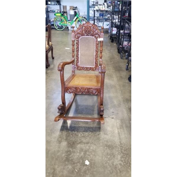 HIGHLY CARVED ANTIQUE CANE BACK ROCKING CHAIR WITH DRAGON MOTIF