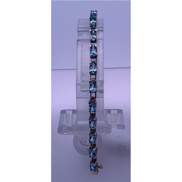 10k white gold blue topaz bracelet; weighs 6.45 grams
