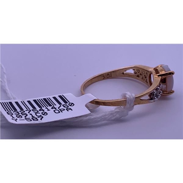 10k yellow gold ring with an opal centre stone, and 6 side melee diamonds; weighs 1.89 grams.