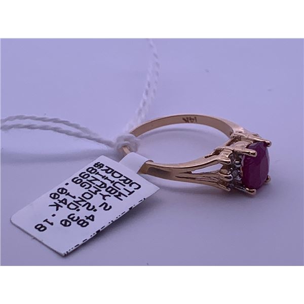 14k yellow gold ring with a ruby centre stone, and 6 melee diamonds; weighs 2.96 grams.