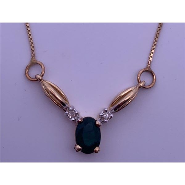 10k yellow gold necklace with emerald, accented by two melee diamonds; weighs 2.43 grams.