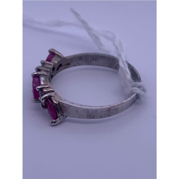 10k white gold ring with 4 pink stones, and 6 small clear stones accenting; weighs 2.06 grams.
